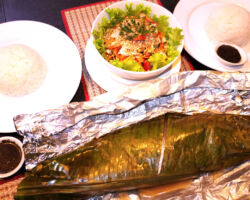 Fresh whole fish wrapped and steamed in banana leaf. Kampot, Cambodia.