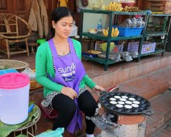 Our favorite street vendor making coconut pancakes. These things were out of this world good. Luang Prabang, Laos.