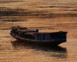 River boat at sunset. Luang Prabang, Laos.