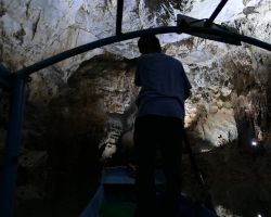 Our captain rowing us (at the front of the boat) on the river inside the Phong Nha cave. Phong Nha, Vietnam.