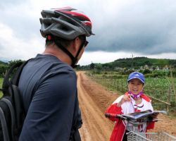 Local girl who stopped us on our muddy bike ride through the Bon Lai valley. She wanted to practice her english. Phong Nha, Vietnam.