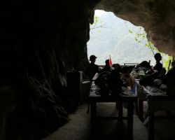 Silhouette view inside Hospital Cave entrance. Cat Ba Island, Vietnam.