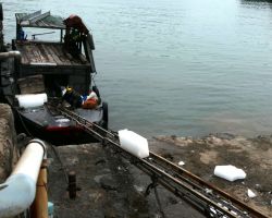 Local ice manufacturer loading blocks onto a boat. Cat Ba Island, Vietnam.