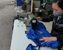 Local lady sewing a tear in Rick's backpack cover. Cat Ba Island, Vietnam.