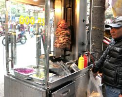 Bahn Mi Kebab stand. Pieces of pork on a rotisserie. Sandwiches are delicious and approximately $1 US. Hanoi, Vietnam.