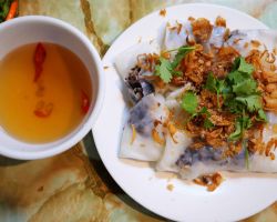 Bahn Cuon. These are a flat fresh spring roll (mushrooms and pork inside). You dip a piece with fresh cilantro into the sauce and eat. Super good. Hanoi, Vietnam.