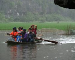 Locals like to overload their boats just like they do on their scooters. Tam Coc, Vietnam.