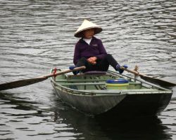 Local tour boat operator (the majority are women and they row with their feet). Tam Coc, Vietnam.