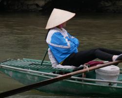 Local boat tour guide (the majority are women and row with their feet). Tam Coc, Vietnam.