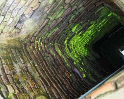 Looking down inside the ancient Ba Le Well. Hoi An, Vietnam