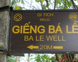 Sign directing tourists to the ancient well. The well is tucked down a small alley and sits in the back of what looks to be a small house. Hoi An, Vietnam