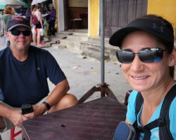Rick and Alisa waiting for their order of Cao lau and Bahn My from one of the street vendors (note the kid's sized plastic table and chairs). Hoi An, Vietnam.
