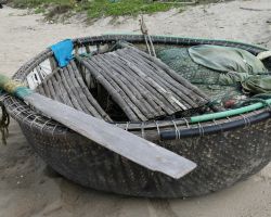 Small round fishing boat with fishing equipment. Hoi An, Vietnam.
