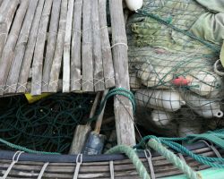 Close-up of fishing equipment stored inside one of their small round fishing boats. Hoi An, Vietnam.