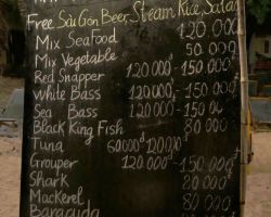 The nightly BBQ menu. The prices are in dong. The currency conversion was slightly over 22,000 dong to $1 US. Phu Quoc, Vietnam.