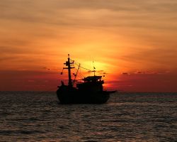 Dramatic sunset behind Vietnamese trawler. Phu Quoc, Vietnam.