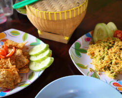 Urap-urap dish on the right (shredded coconut, veggies, spices) and Tempe on the left (furmented corn mixture and fried). Both were outstanding. Our Senaru guide made this as part of our lunch. Senaru, Indonesia (Lombok).