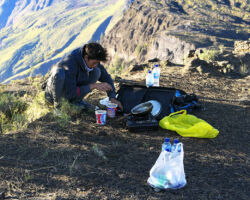 Akim, our summit guide, cooking us hot noodles on the crater rim after our summit. Mt Tambora, Indonesia (Sumbawa).