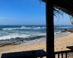 View from the restaurant at Rathna Guesthouse on Dalawella beach. Dalawella, Sri Lanka.