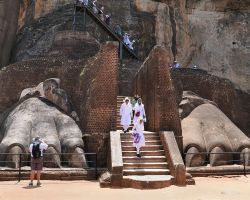 Both lions feet with people in the photo for size comparison. Sigiriya, Sri Lanka.