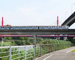 The MRT Red Line (one of several throughout the city) is passing above us on the bike path. Greater Taipei, Taiwan.