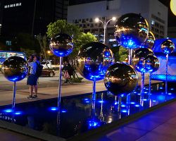 Chrome ball art sculpture at night. Greater Taipei, Taiwan.
