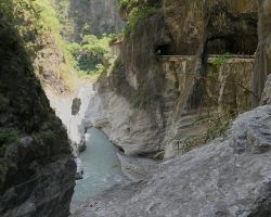 Looking back at road tunnels in the rock at Swallow Grotto in Taroko Gorge. East Coast, Taiwan.