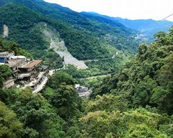 View of the upper cable car landing above the falls on the left and at center typhoon slide damage in the distance. Northern Area, Taiwan.